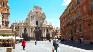 A cathedral stands in a bustling city square.